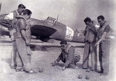 Tenente (Lieutenant) Felice Figus (on the right pointing) and a group of other pilots from the 368º Sturmo stationed at Palermo, Sicily, in June 1943 passing time in between missions playing a game of bocce near a Macchi 202 (courtesy of the Felice Figus family)